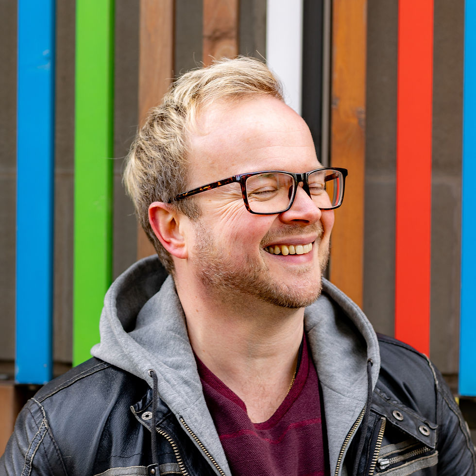 marc godfrey from marco looks illustration smiling with rainbow background