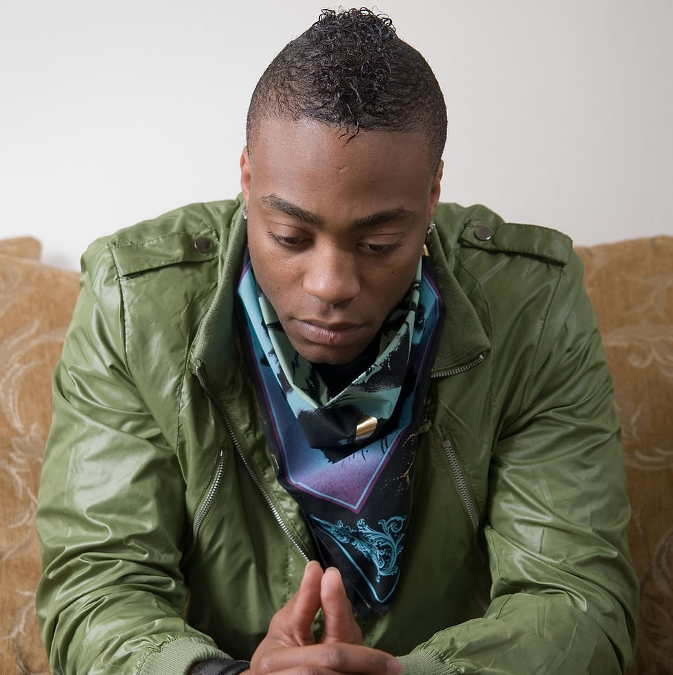 African American man in green jacket looking concerned