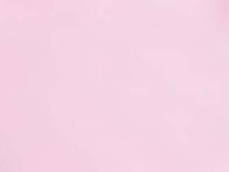white abortion pills on a pink background