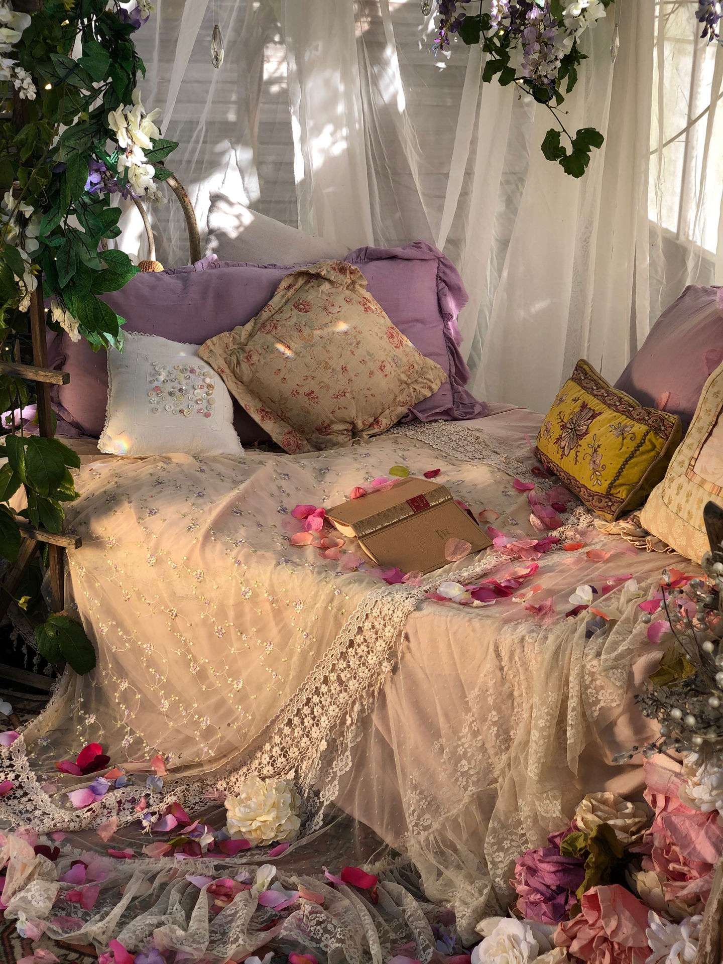 a bed with purple pillows and a book on it