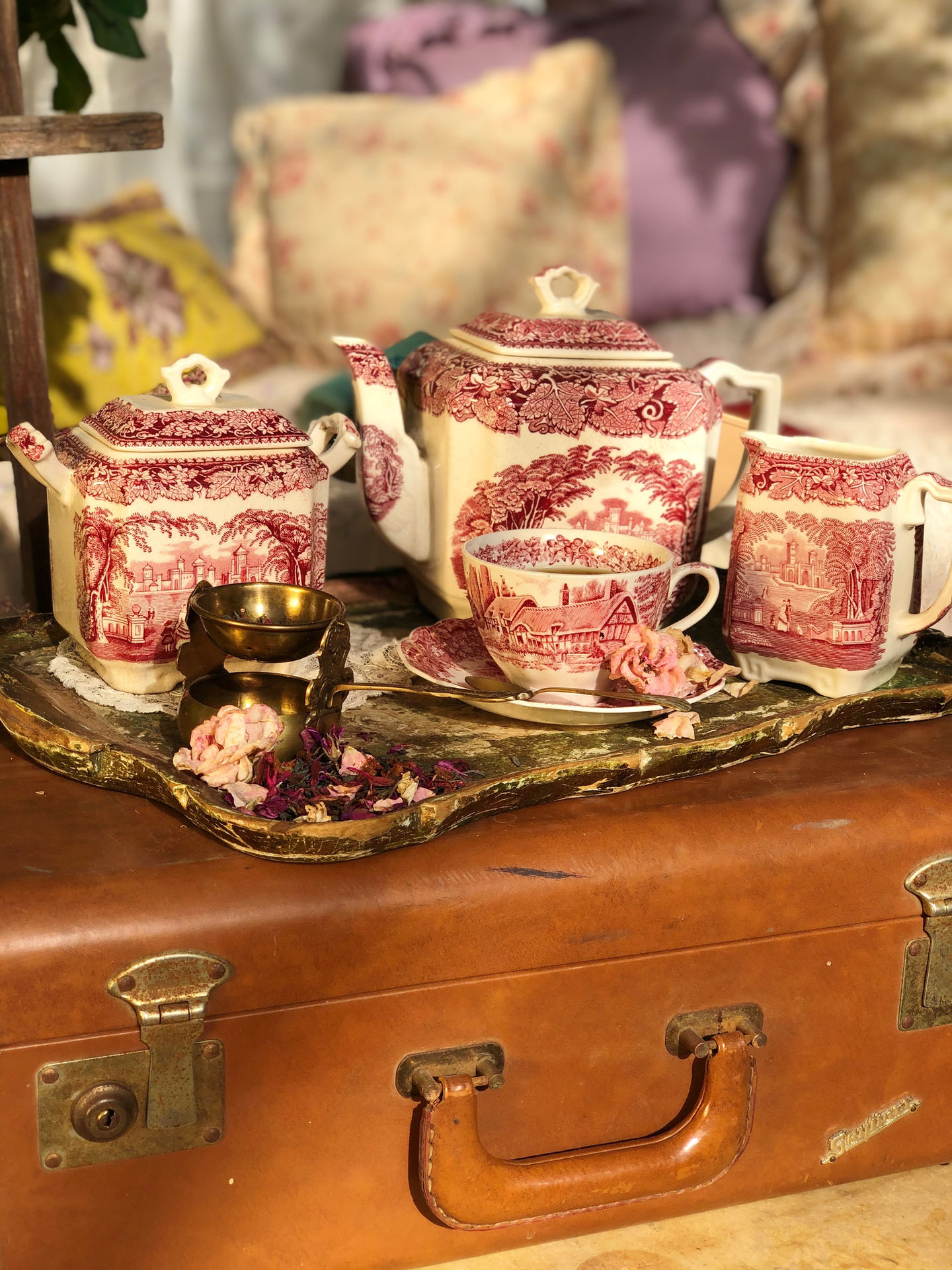 a red and white tea set sits on a tray