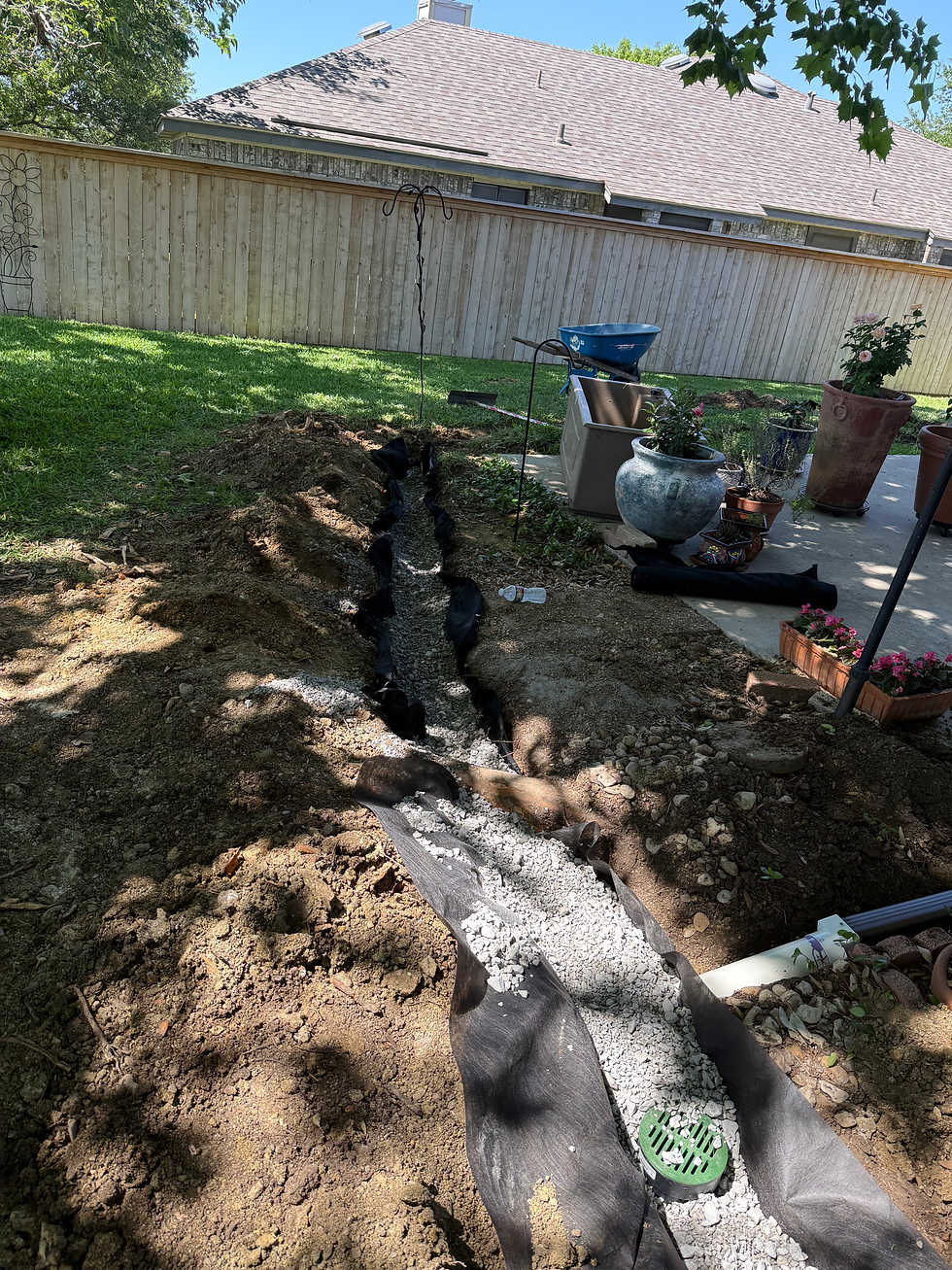 Underground drain line being installed to fix a soggy yard in Fort Worth