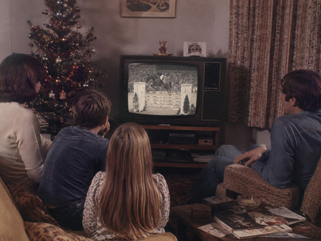 British family watching showjumping on television at Christmas in the 1970s