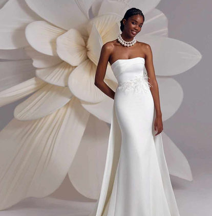 Bride wearing the Eva Lendel Amalfi fitted crepe wedding dress with asymmetric neckline and detachable floral feather belt at Elizabeth Kate Bridal.