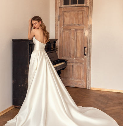 Bride wearing the Eva Lendel Lika strapless Mikado wedding dress with detachable overskirt.
