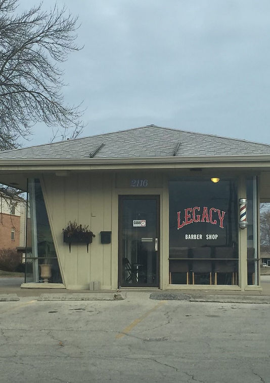 "Exterior of Legacy Barbershop's original location in Lawrence, KS, showcasing the vintage charm and cozy feel.