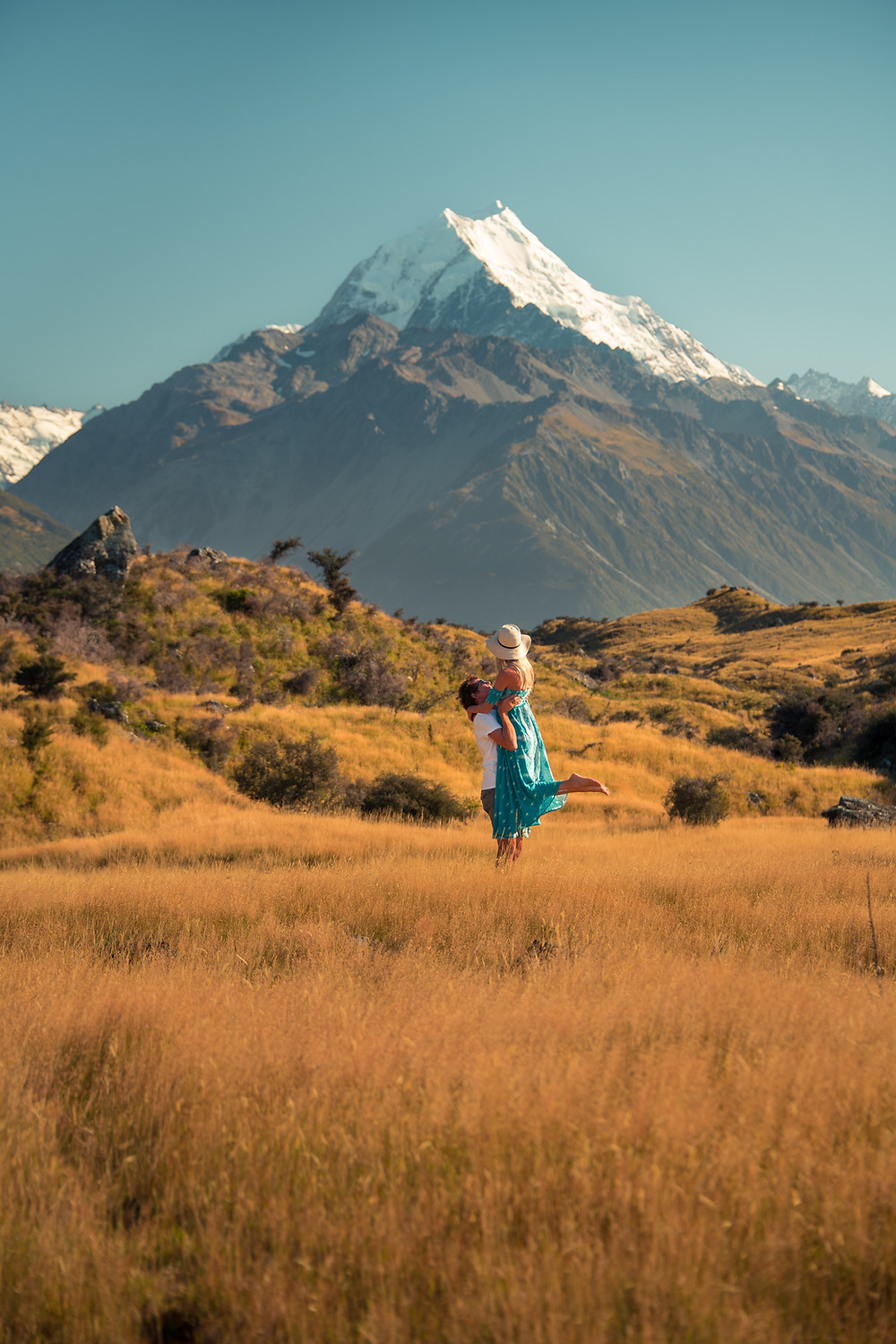 couple with man lifting woman in front of mt cook