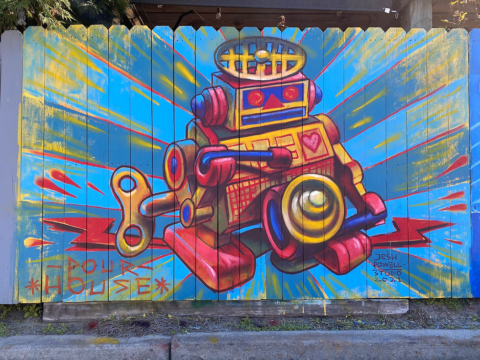 An exterior mural for Pour House by Joshua Powell, featuring a whimsical robot in spray paint over a blue sunburst