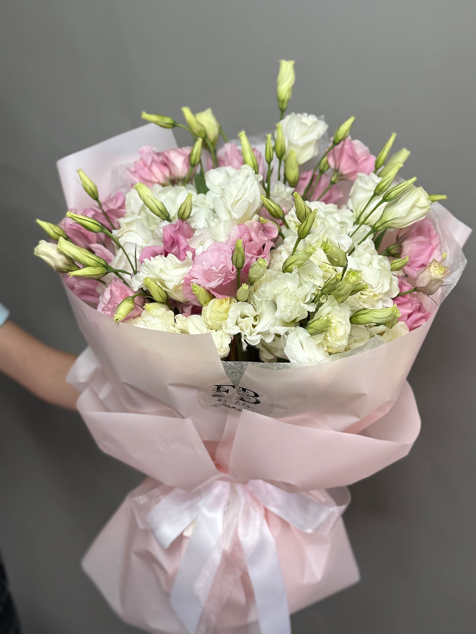 bouquet in pink packaging of spring flowers