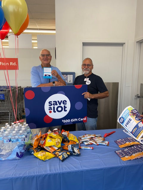 Greg Witte, pantry director, accepts a $500 gift card from a local Save-A-Lot that will be used to purchase tuna.
