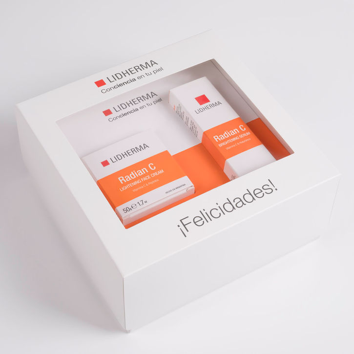 Caja de regalo Lidherma con crema facial y serum Radian C sobre fondo blanco.