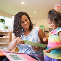 Montessori teacher showing child a photo