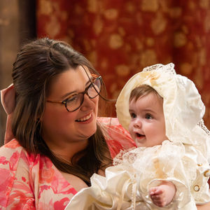 Beautiful baby being looked at in wonder by their mother.