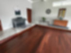 Damaged wooden floor area in living room before removal