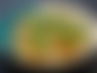 Bowl of Japanese simmered turnip with fried tofu and green snap peas in light broth, on a dark surface.