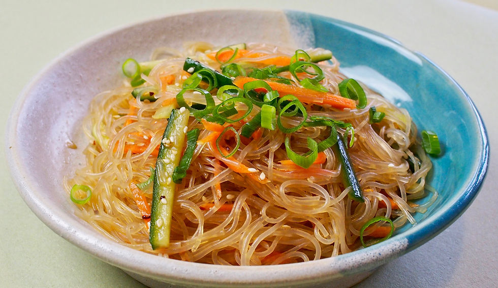 Harusame Spring Rain Bean Thread noodle salad with a soy sauce and sesame dressing with carrot and cucumber garnished with white toasted sesame on a hand fired glazed dish by kurumicooks delicious easy to make healthy Japanese Asian and fusion cooking for your kitchen