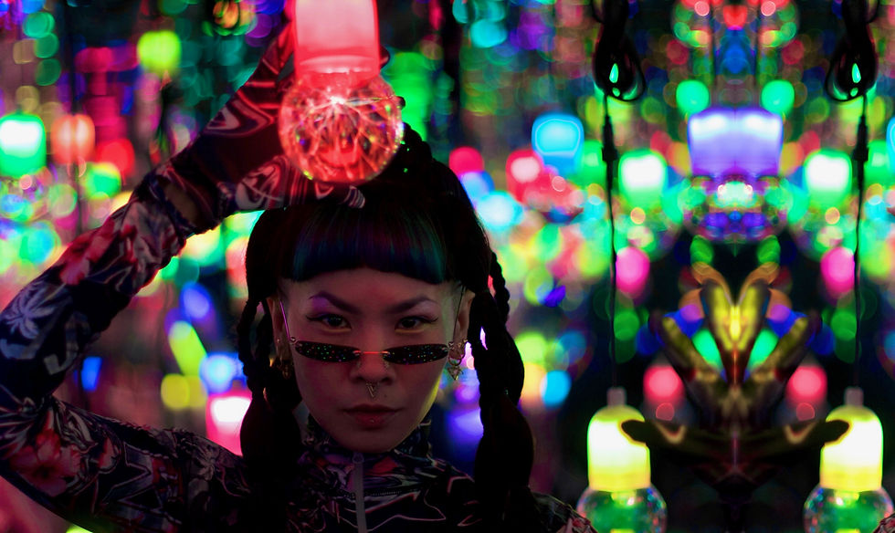 POW holding a glowing red bulb in a room of neon lights