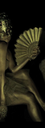 POW in gold body paint wearing a gold tutu and a gold mask holding a fan leaning between rocks in the dark