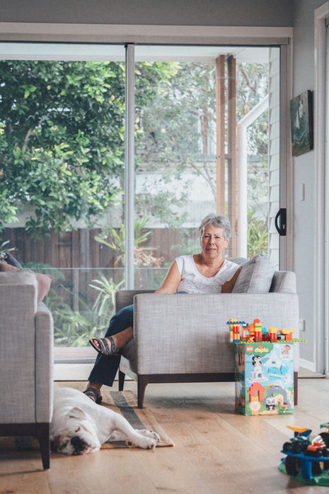 A contact sheet of candid indoor family photography. The images capture a mother, father, and two young children engaging in everyday activities