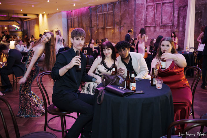 Group of university students enjoying a lively party, smiling and dancing in a festive atmosphere