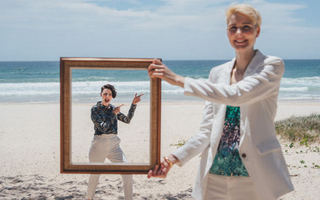 Midday elopement at Kingscliff Beach with two brides sharing candid, emotional moments by the shore.
