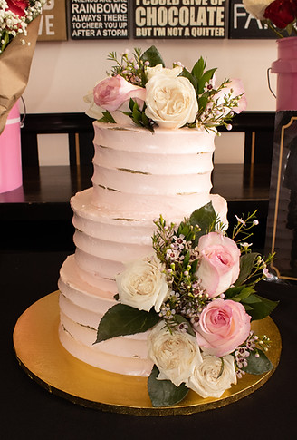 Elegant three-tier cake with pink and white roses