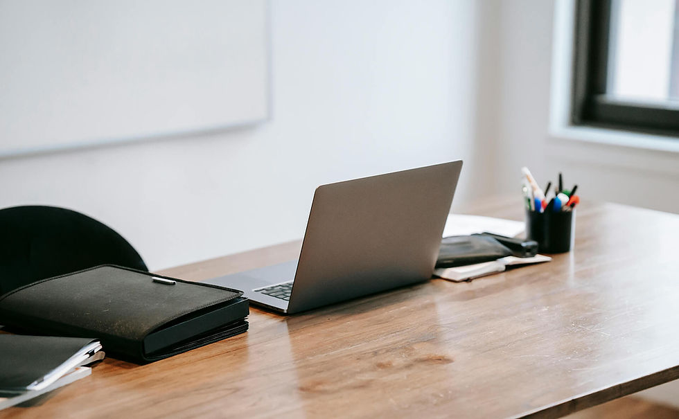 Laptop on wooden desk with office supplies, staging-jenschipper in a workspace setting.
