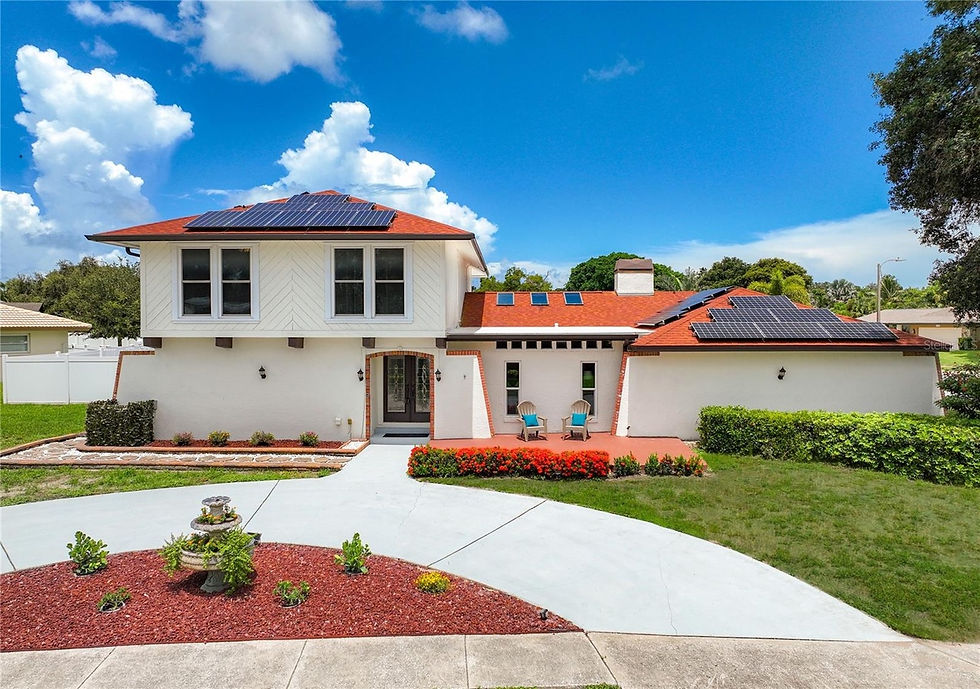Exterior view of a white house with red trim and driveway. staging-jenschipper