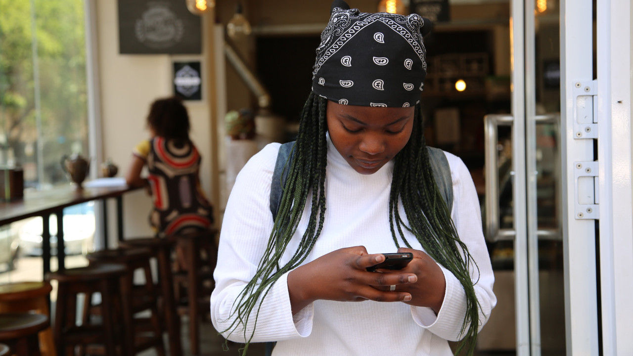 woman holding phone in a coffeeshop