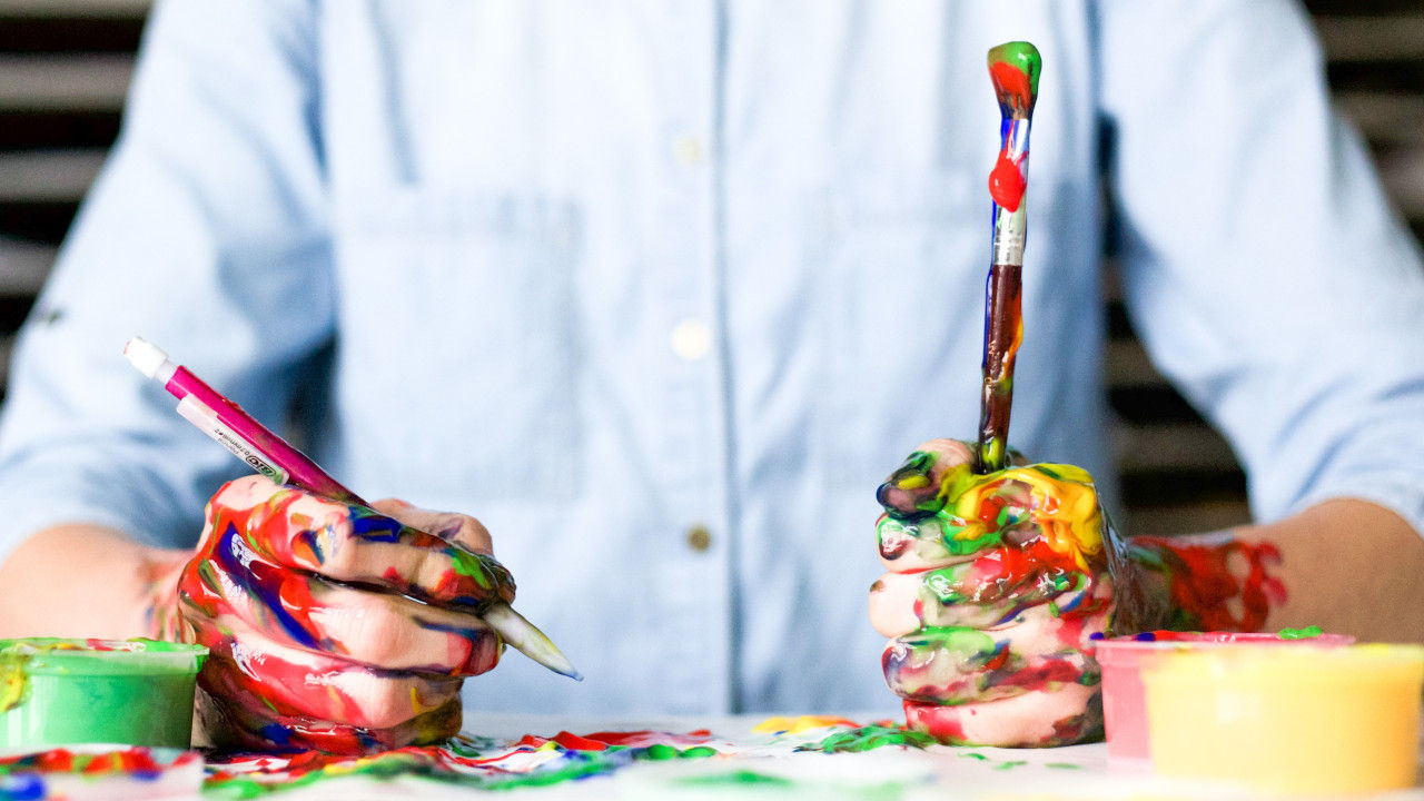 Man sitting on table painting