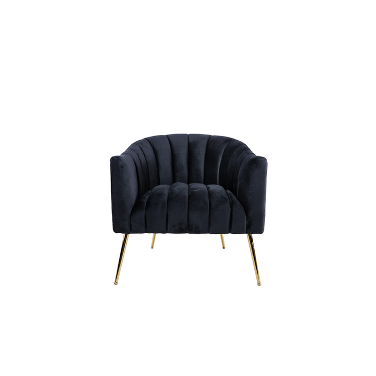 Black velvet accent chair with vertical channel tufting, a rounded back, and tapered gold metal legs.