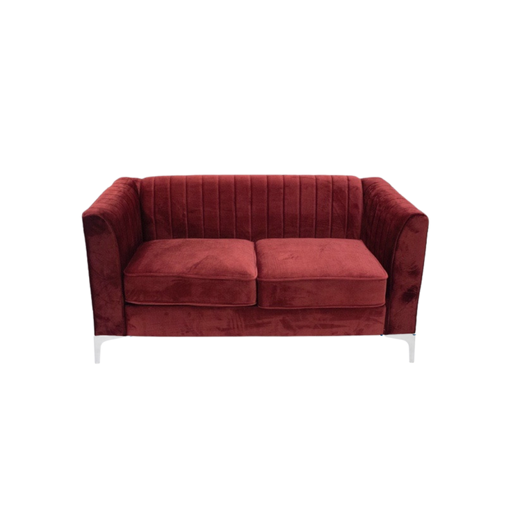 Burgundy velvet loveseat with vertical channel tufting, curved arms, silver legs, and a modern silhouette.