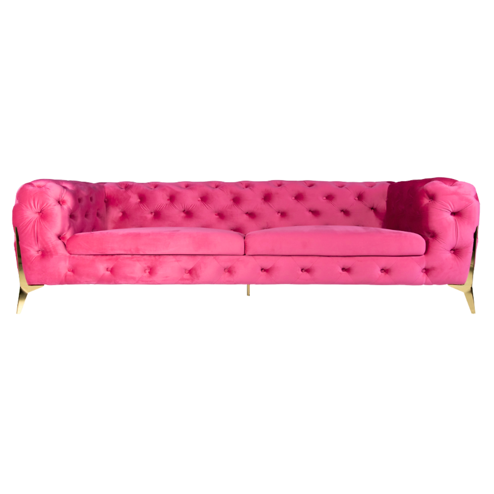 Hot pink velvet sofa with deep button tufting, rolled arms, gold metal legs, and a contemporary silhouette.