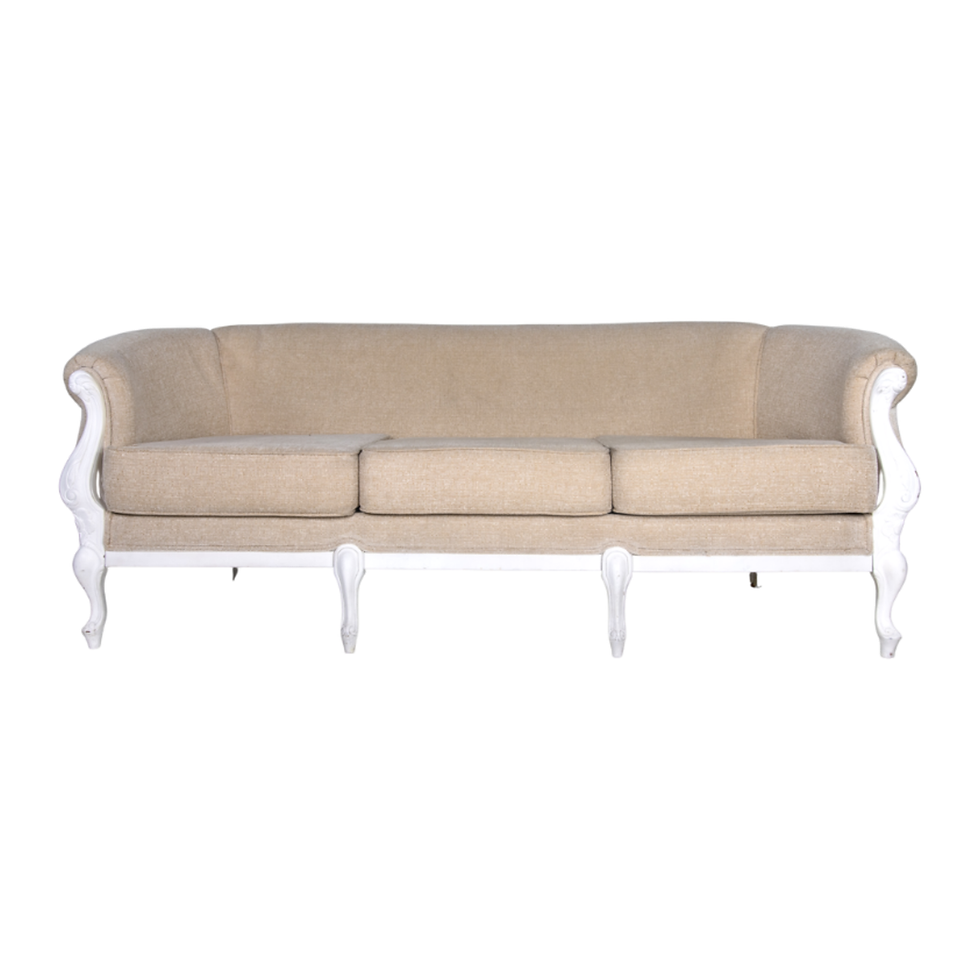 Natural linen sofa with rolled arms, carved white wood frame, plush cushions, and a classic French silhouette.