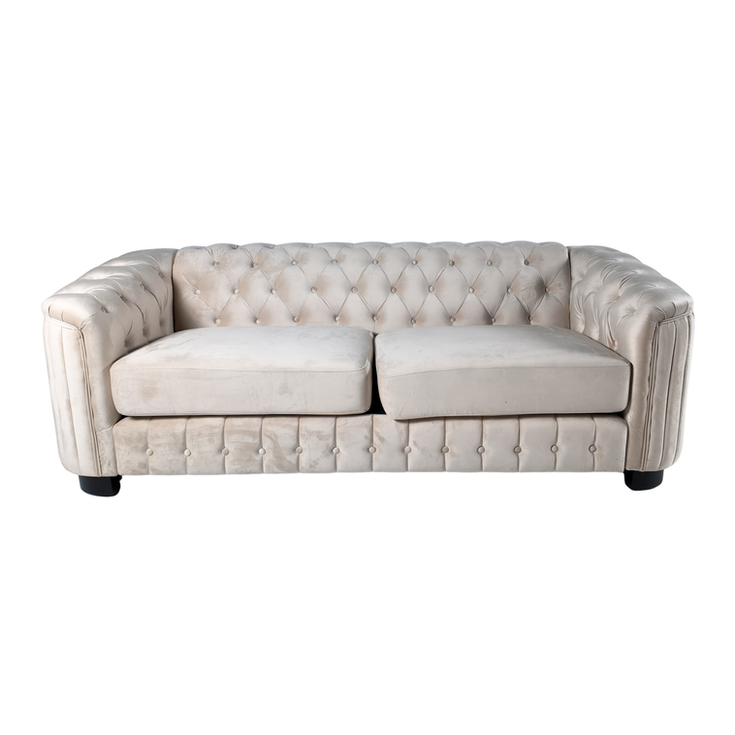 Ivory velvet sofa with deep button tufting, rolled arms, plush cushions, and a classic Chesterfield silhouette.
