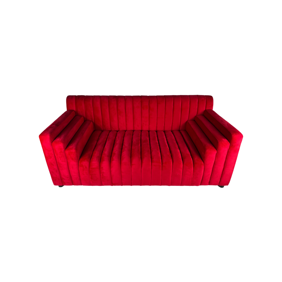 Ruby red velvet loveseat with vertical channel tufting, wide arms, and a low-profile modern design.