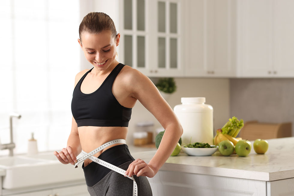 Weight loss Woman measuring waist with tape in kitchen.jpg