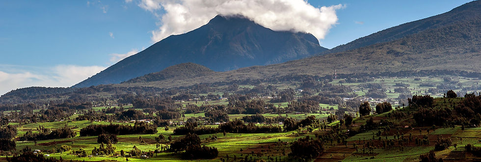 Scenic view of Mount Bisoke with surrounding hills and forested landscape