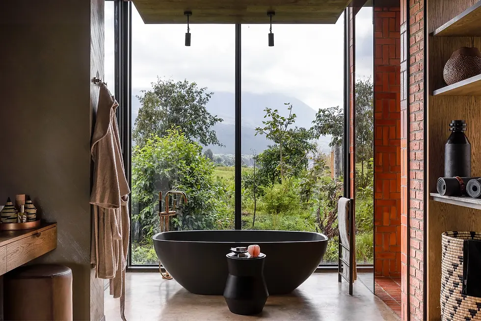 Panoramic view of the Virunga Mountains from the terrace of Singita Kwitonda Lodge, showcasing lush peaks and valleys