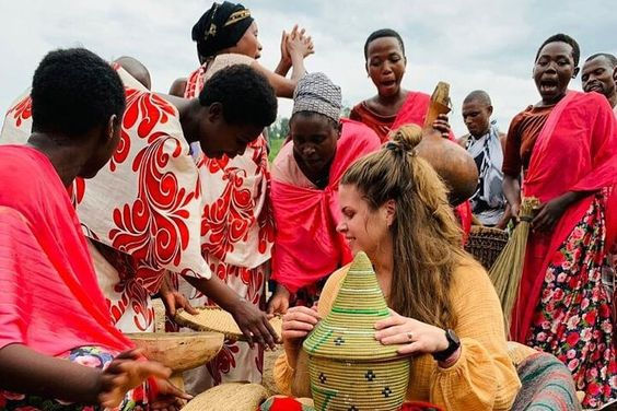 Tourist cooking traditional Rwandan food with a local guide during a cultural experience in Gakenke.