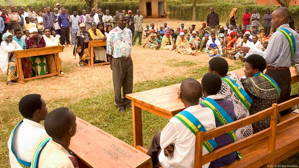 Eye-level view of a community gathering in Rwanda discussing reconciliation