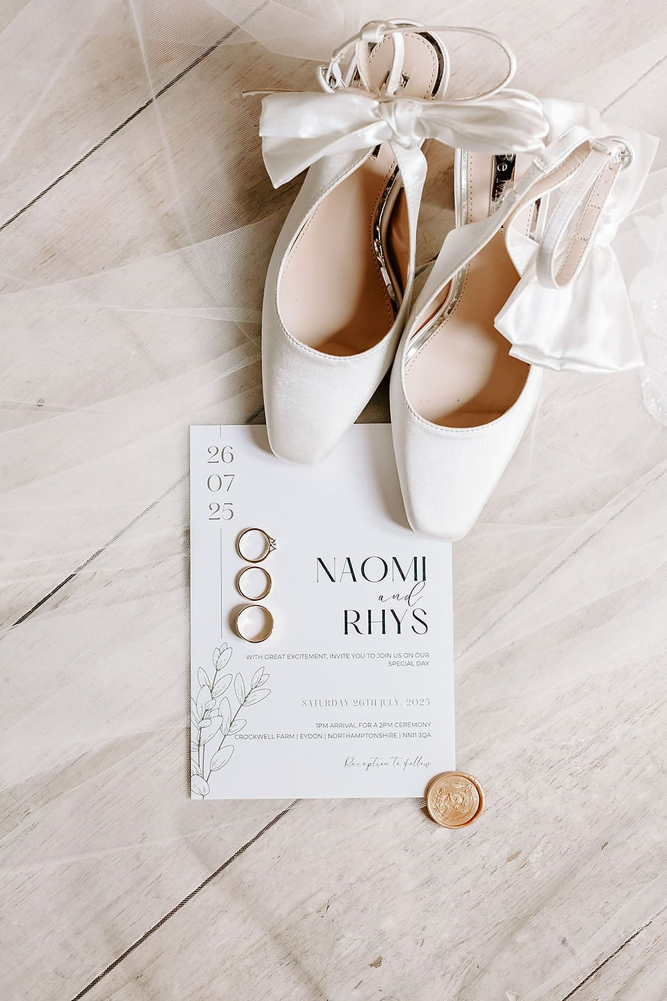 Flat lay of wedding invitations and accessories with natural tones