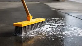 Concrete surface being scrubbed and cleaned to remove grime and buildup during professional concrete cleaning by Level Best Northwest