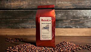 Bag of coffee sitting on coffee beans