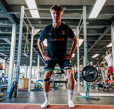 Youth soccer player engaging in weight training to improve strength and conditioning as part of the Full Season Soccer Portugal program