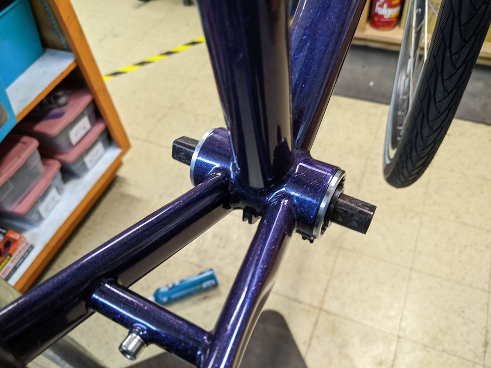 Bottom bracked installed onto the bottom of the frame. The square bolts are sticking out of the sides.