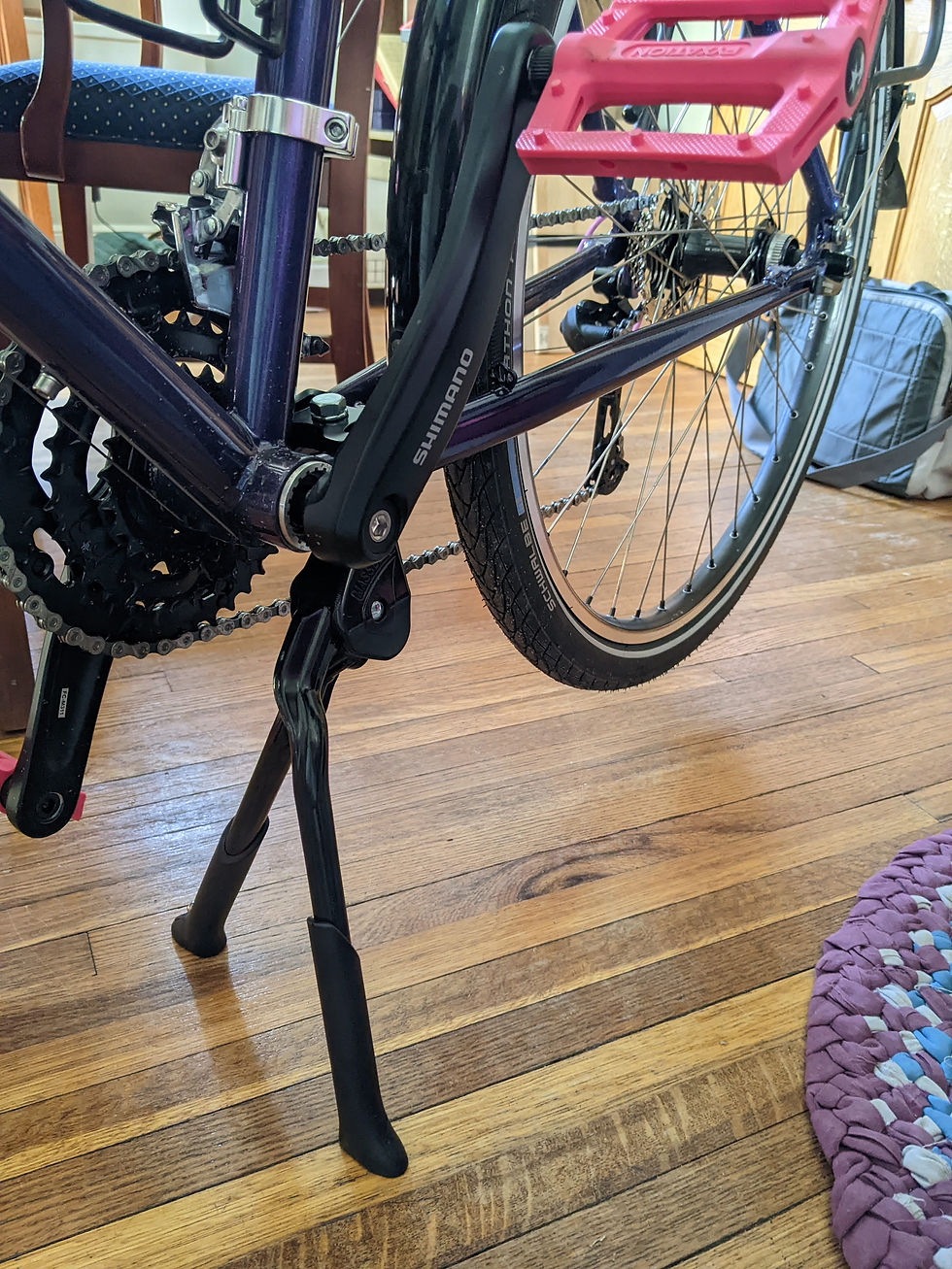 double leg kickstand mounted on the bike. The rear wheel is floating above the floor.
