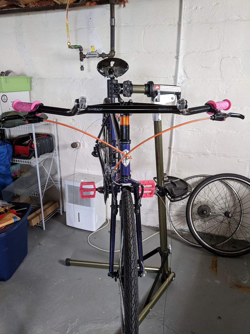 front view of bike showing orange cable housing crossing and attaching to front brake