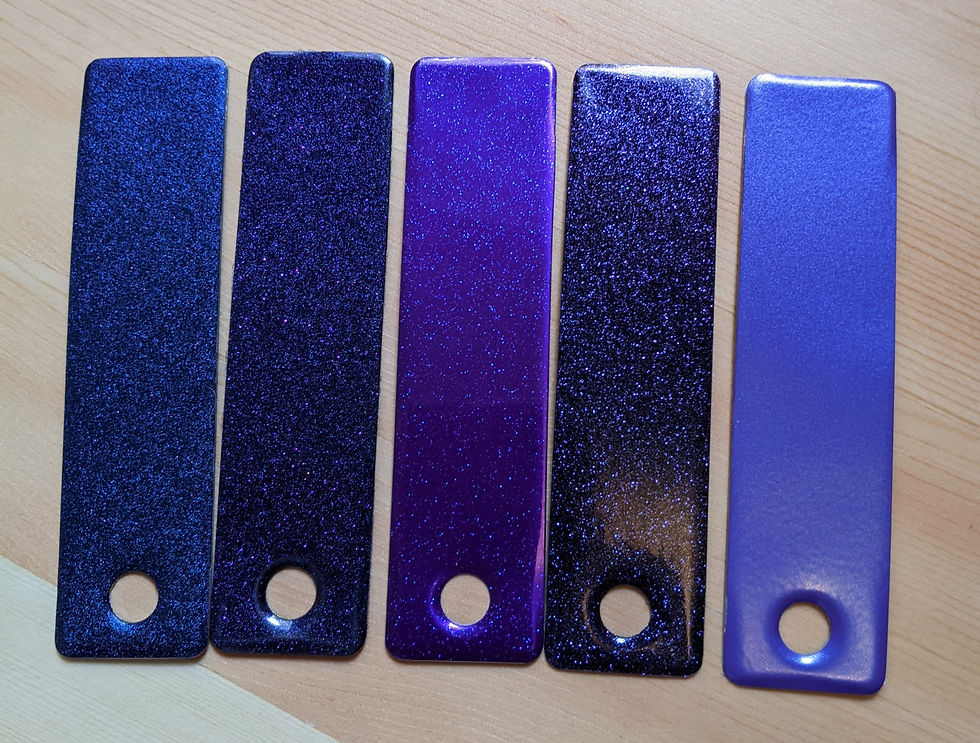 Five sparkly purple paint swatches, ranging from blueish-purple to reddish-purple to metallic blue purple.