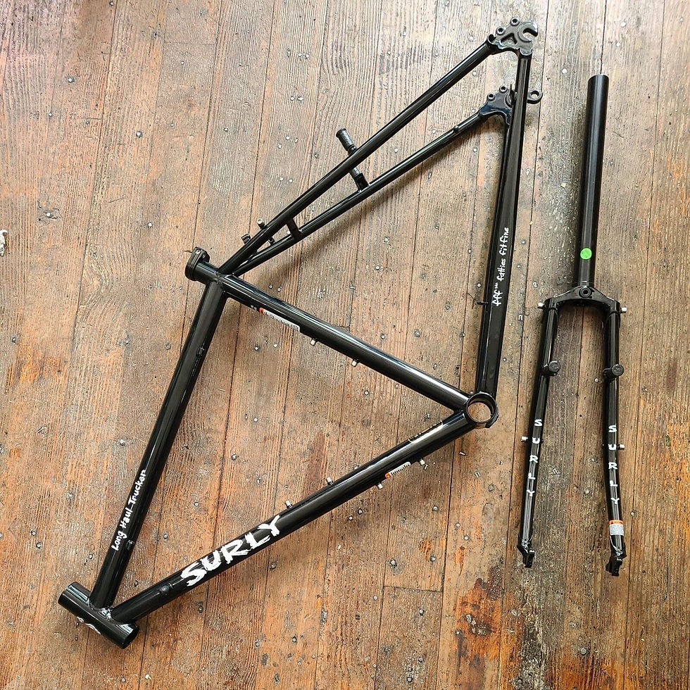 Black bike frame and fork with decals that say "Surly" and "Long Haul trucker"